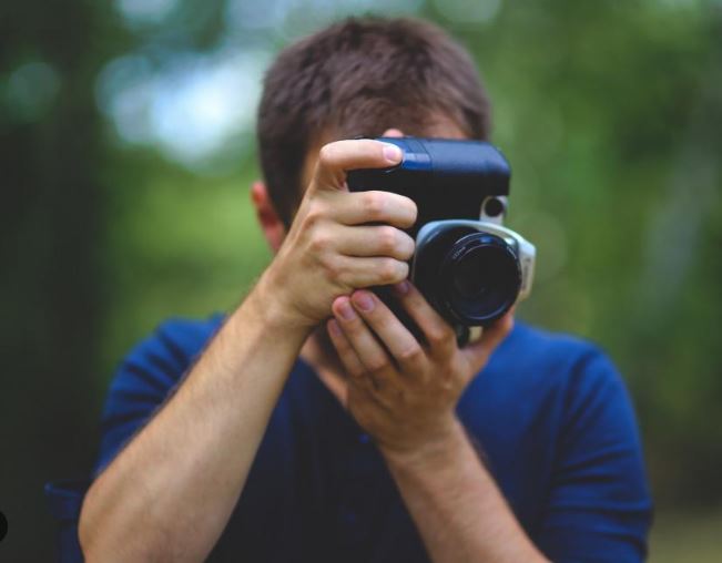 person taking a picture with a camera